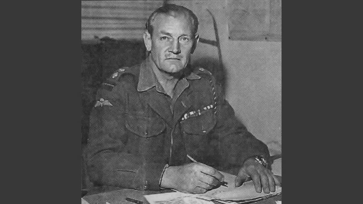 old black and white image of an older Lt Col Jack Churchill sitting at a desk