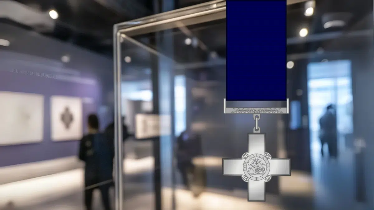 A close-up of the George Cross medal in a glass display case with a caption reading "Violette Szabo," dramatic lighting and historical display elements, clean museum background with people passing by.