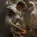 a young blond prince in a white and gold tunic kneels and plants long dragon's teeth glowing in the dirt