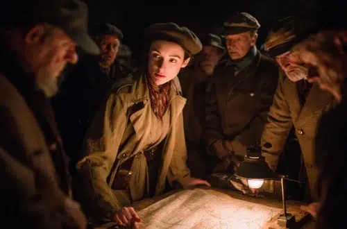 Virginia Hall standing over a map briefing resistance fighters