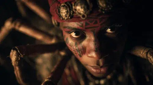 Close up of Anansi the Spider from West African folklore, a human form but with eight long spider legs, faint African symbols and storytelling spirits in the background